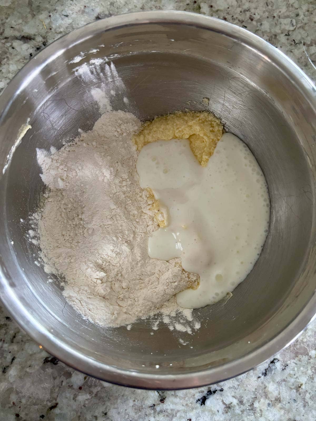 Adding the dry ingredients and buttermilk to the butter and sugar mixture.