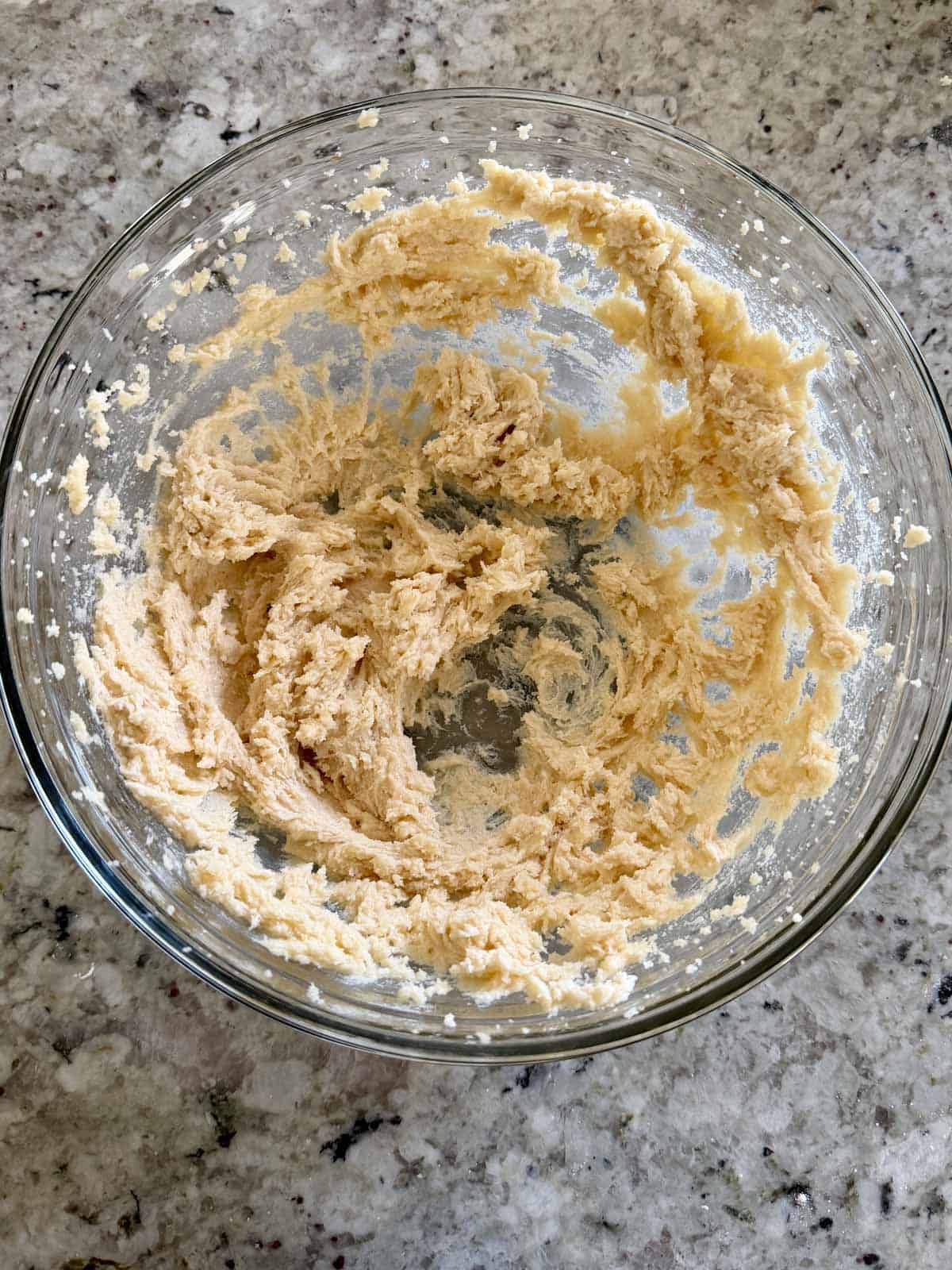 Creamed butter and sugar in a bowl showing how fluffy it is.