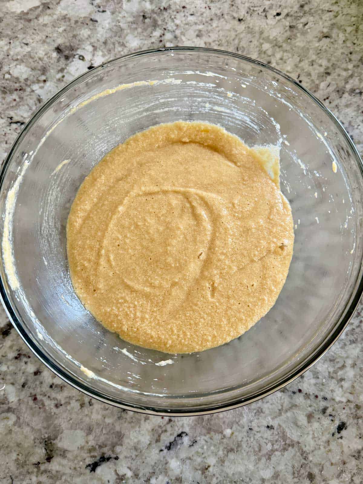 Eggs being added to the butter sugar mixture and mixed until combined.