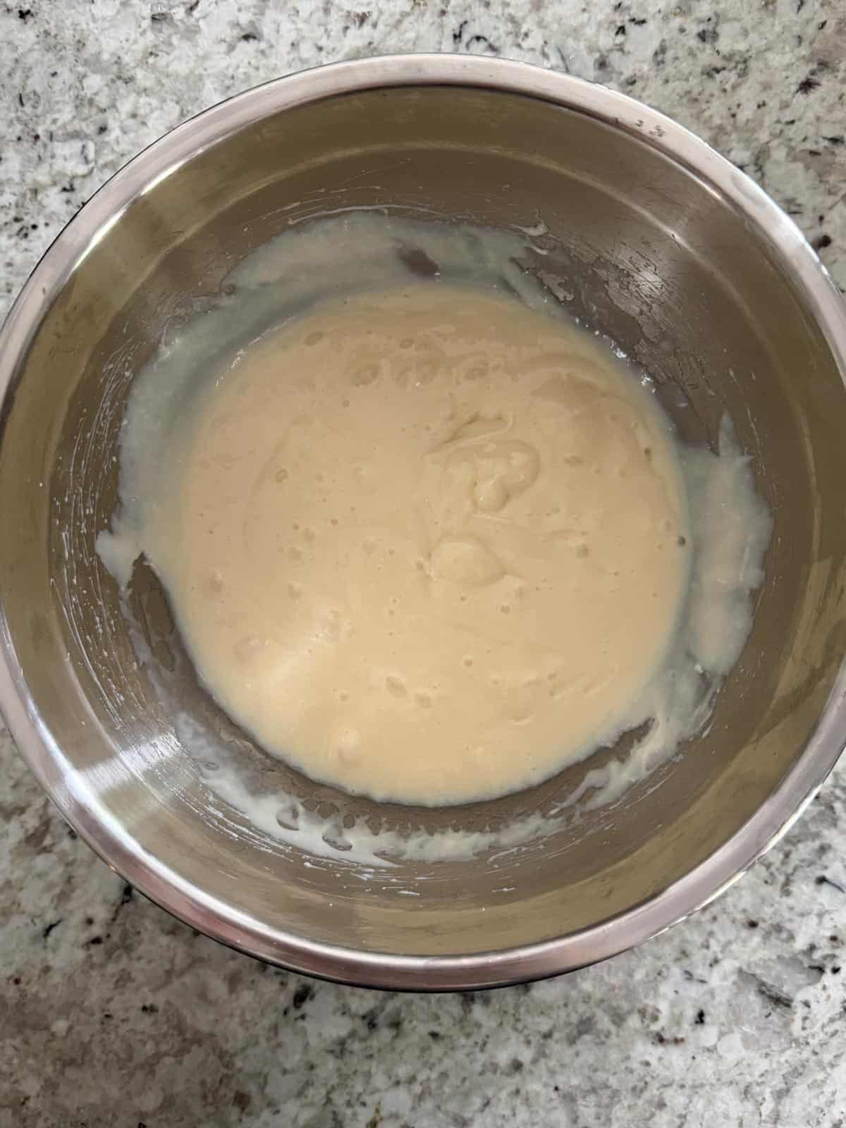 Sweetened Condensed milk and cream cheese beat until smooth in a bowl on the counter.