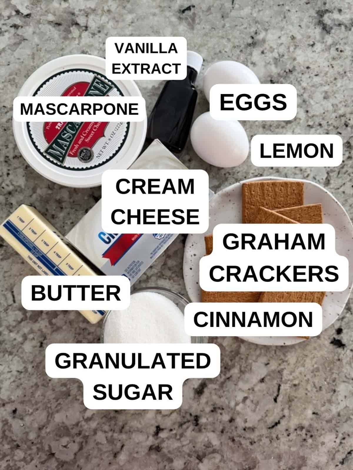 Labeled ingredients for the cheesecake recipe on the counter.