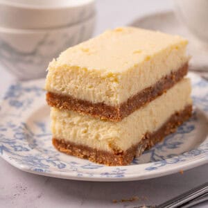 A closeup of the mascarpone cheesecake texture and graham cracker crust on a plate.