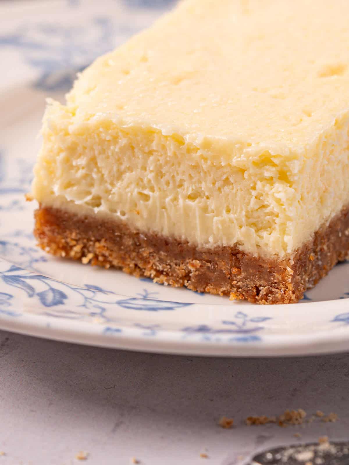 Showing the smooth and creamy texture of the cheesecake on a plate.