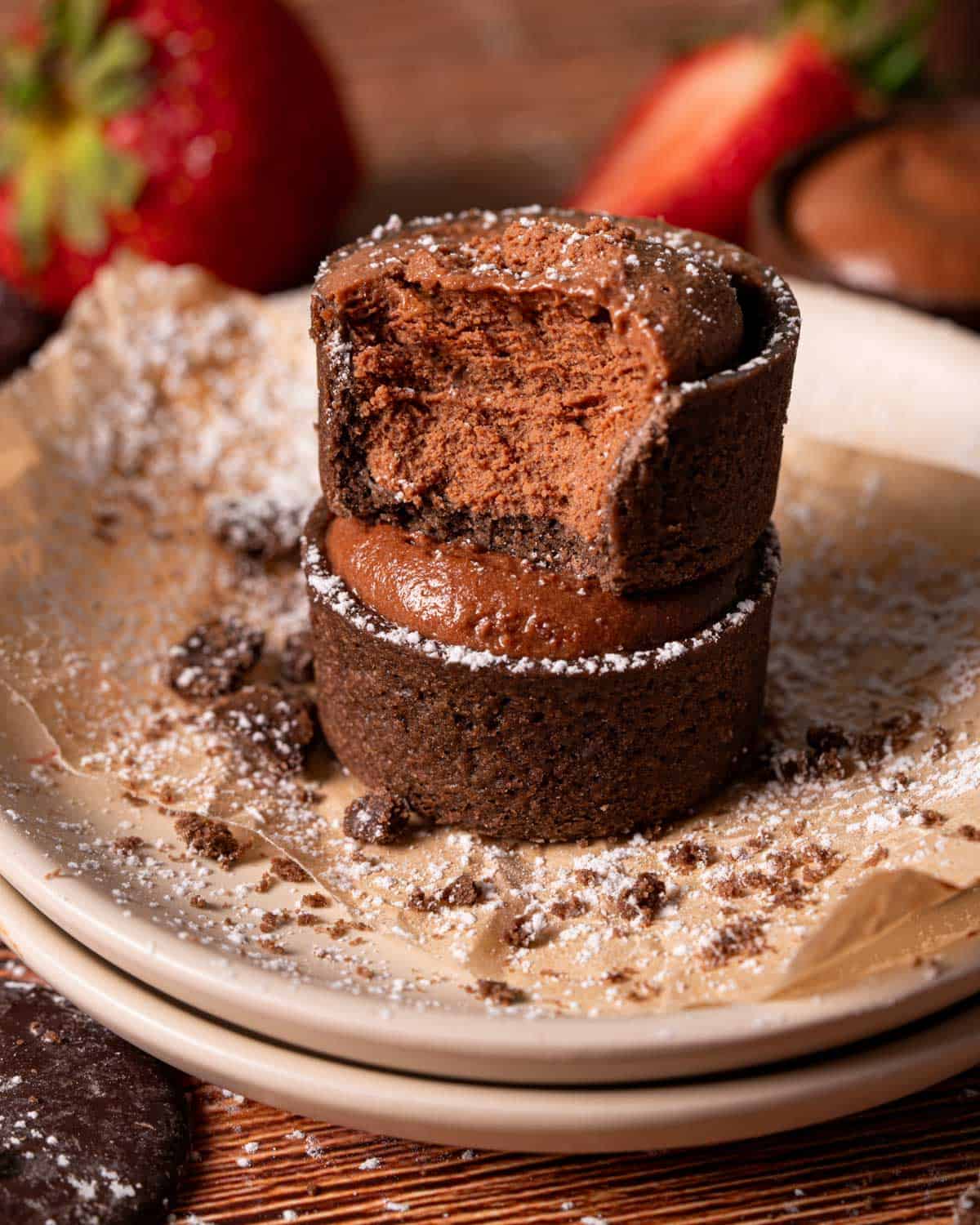 Easy chocolate strawberry tarts stacked on top of each other on plates.
