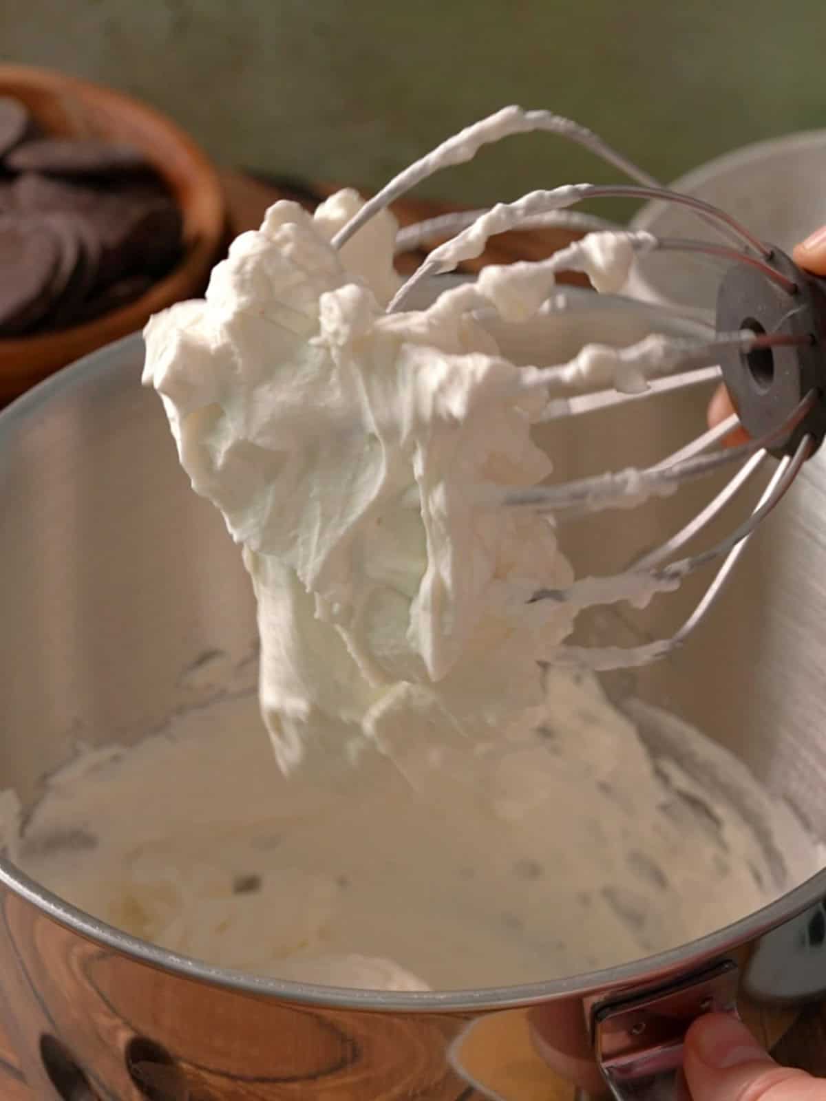 Showing the heavy cream whipped to stiff peaks on a beater attachment.