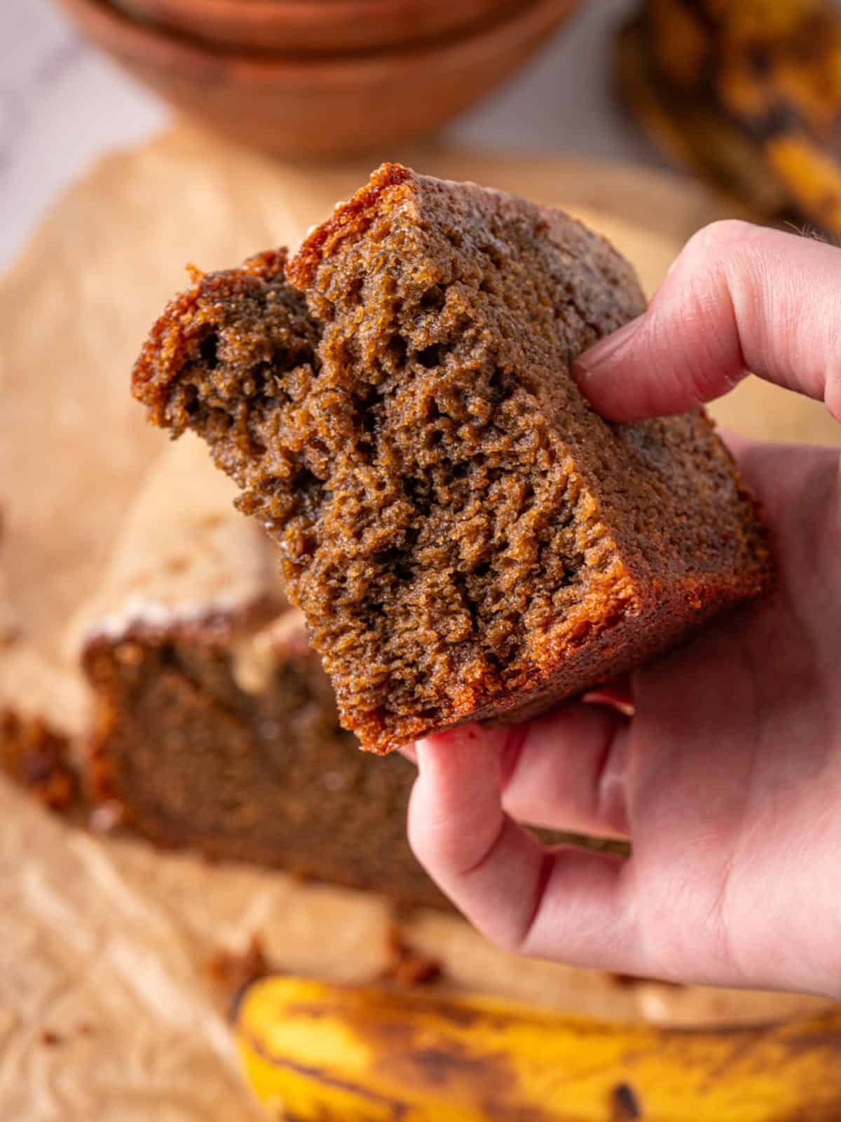 Espresso banana bread being held up showing the texture and moist slice.