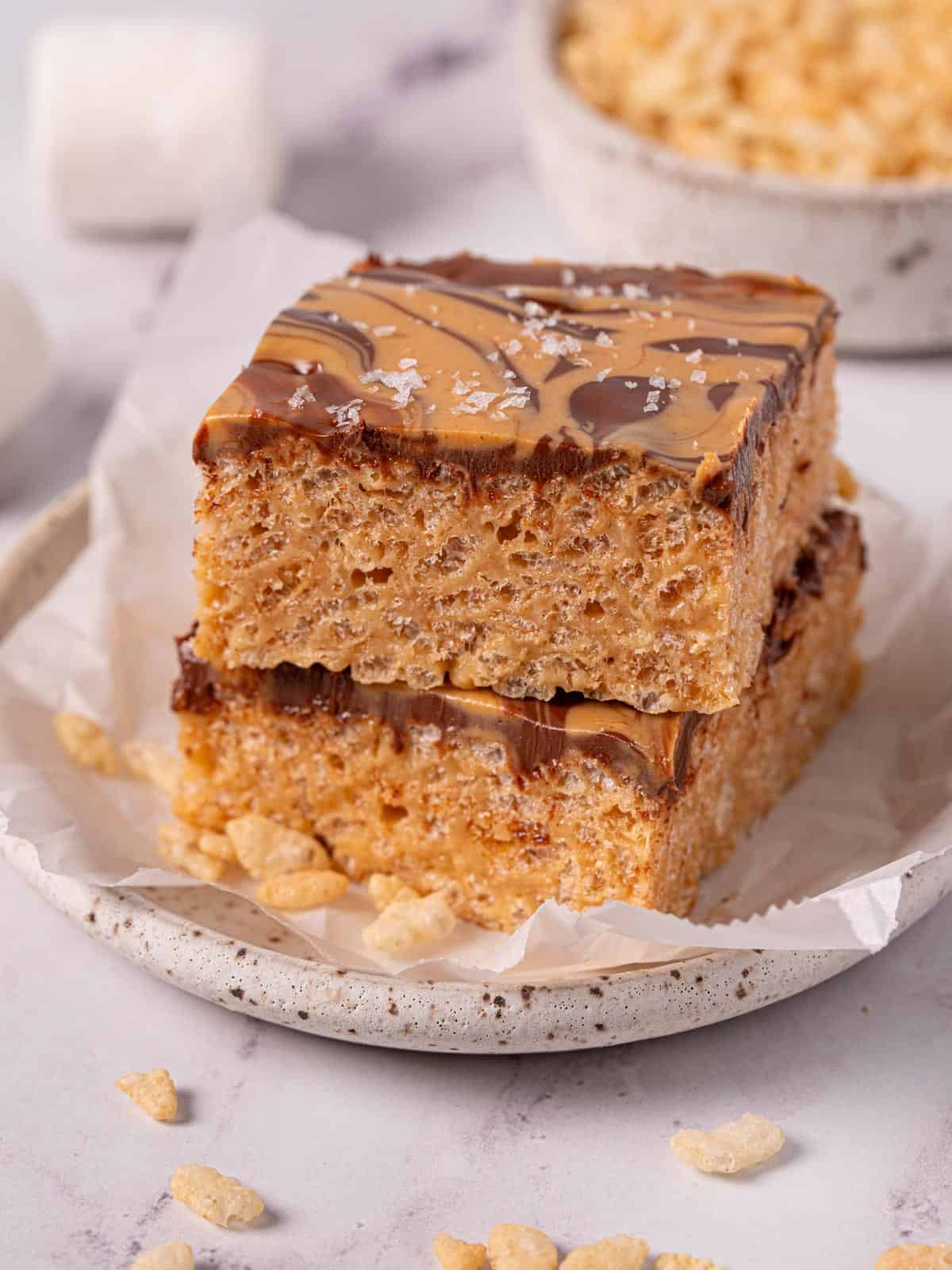Chocolate and peanut butter rice krispie treats stacked on top of each other with peanut butter swirl.