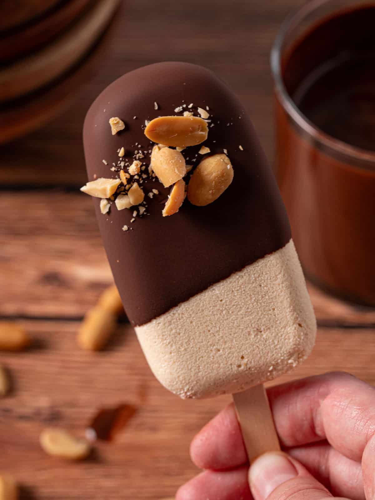 Showing the peanut ice cream with chocolate and peanuts on it.