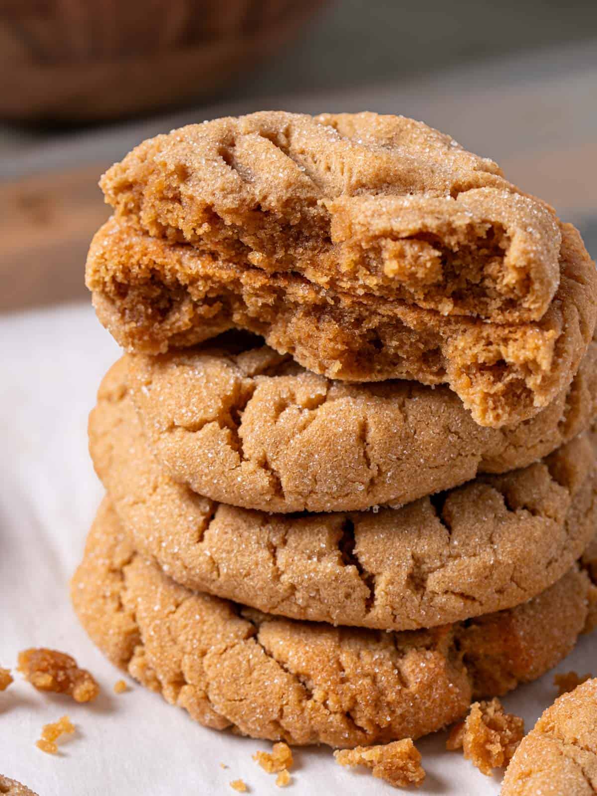 A peanut butter cookie cut in half showing the soft texture of the inside of the cookie.