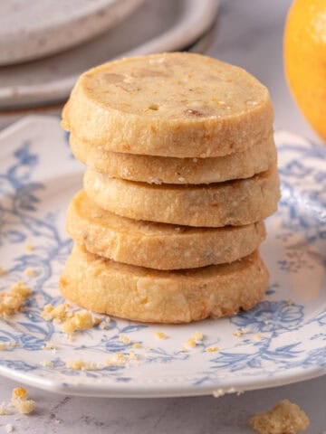 A stack of walnut shortbread cookie recipe on a plate on the counter.