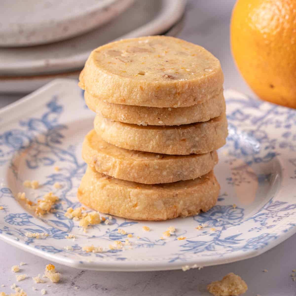 A stack of walnut shortbread cookie recipe on a plate on the counter.