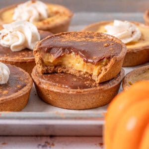 Pumpkin tarts with pumpkin pastry cream stacked on top of each other showing the texture.