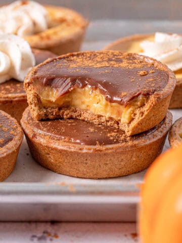 Pumpkin tarts with pumpkin pastry cream stacked on top of each other showing the texture.